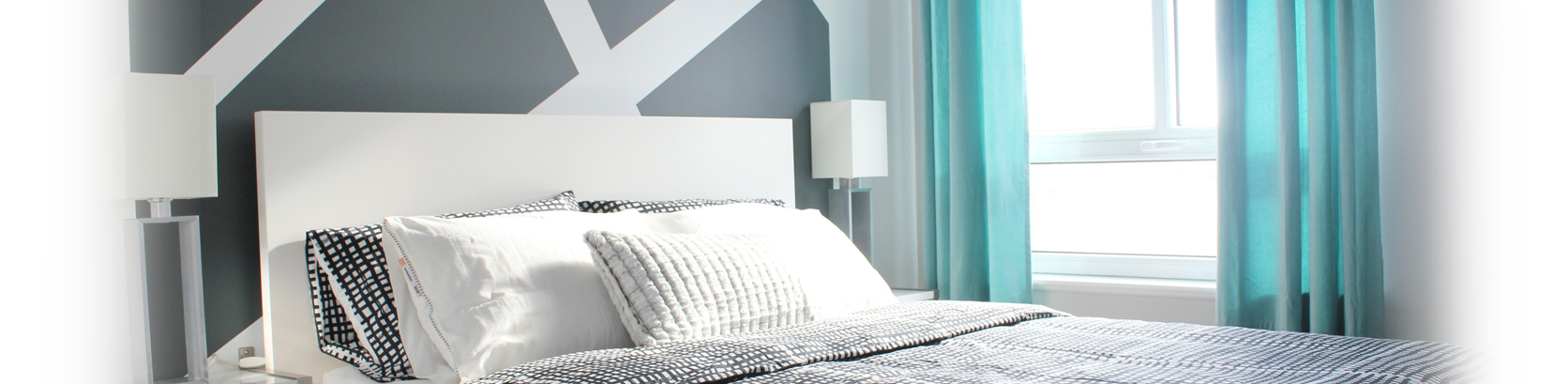 White headboard, crystal lamp, silk curtains, graphic pillows